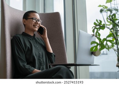 Non binary office worker resting in office lobby - Powered by Shutterstock - Get 15% off with code: PIKWIZARD15
