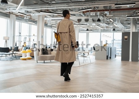 Non binary office worker walking in hallway
