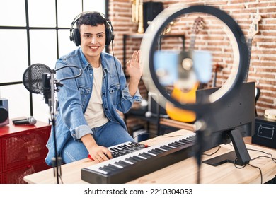 Non binary person doing online music tutorial looking positive and happy standing and smiling with a confident smile showing teeth  - Shutterstock ID 2210304053