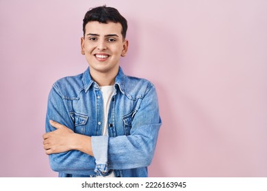 Non binary person standing over pink background happy face smiling with crossed arms looking at the camera. positive person.  - Shutterstock ID 2226163945