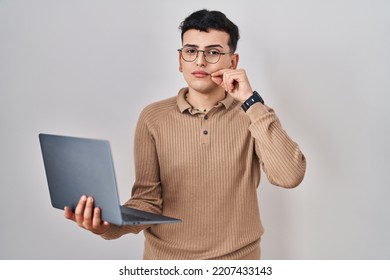 Non Binary Person Using Computer Laptop Mouth And Lips Shut As Zip With Fingers. Secret And Silent, Taboo Talking 