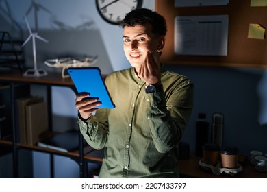 Non Binary Person Using Touchpad Device At Night Doing Money Gesture With Hands, Asking For Salary Payment, Millionaire Business 