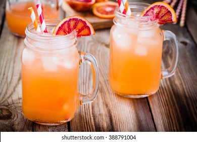 non-alcoholic blood orange cocktail in a glass jar on a wooden background