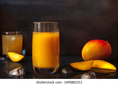 Nonalcoholic Drinks Mango Juice Glass With Whole And Slices Fruit On Black Dark Background. Sober Living Concept Image