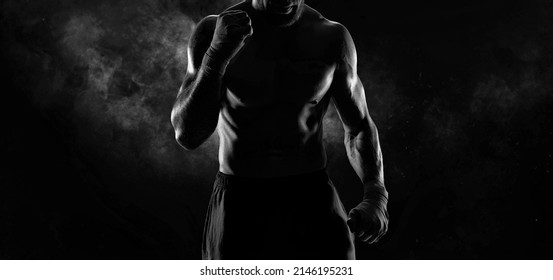 Noname image of a kickboxer on a dark background. The concept of mixed martial arts. MMA