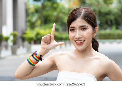 Non-binary LGBT Person Showing L Hand Sign For LGBT Awareness Pride Month