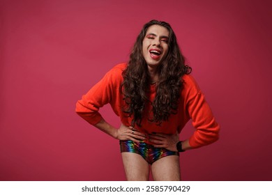 non-binary person is posing on a red studio background Man has an artistic expression. Concept of non-binary people. pride