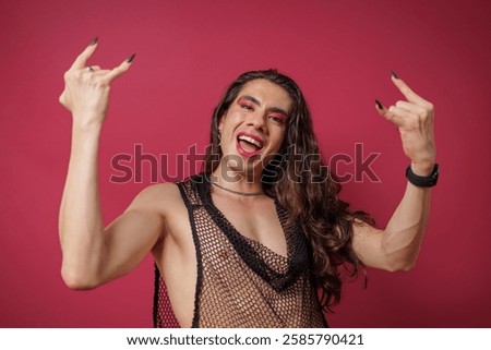 non-binary person is posing on a red studio background Man has an artistic expression. Concept of non-binary people. pride