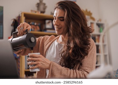 Non-binary person serving coffee at their desk to start the work day