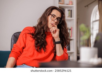 Non-binary person working from home with their laptop with a thoughtful face - Powered by Shutterstock - Get 15% off with code: PIKWIZARD15