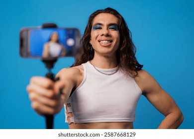 Non-binary stylish person creating content with their cell phone like an influencer
