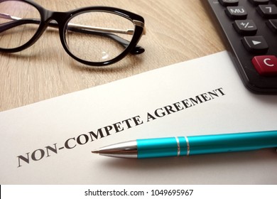 Non-compete agreement document for filling and signing on desk, business competition concept