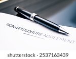 A non-disclosure agreement NDA document featuring a stylish pen, representing confidentiality, legal protection, business ethics, and secure transactions in corporate environments.