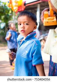 Nong Bua,Thailand - October 31, 2017 : Little Child Boy Eat Delicious Ice Cream. A Cute Asian Shy Boy Enjoy Eating With White Ice Cream And Playing A Yellow Toy Car With Mom On The Street Of Thailand.