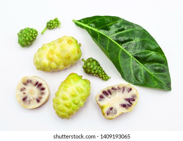 noni fruit with leaf and slice top view on white background.