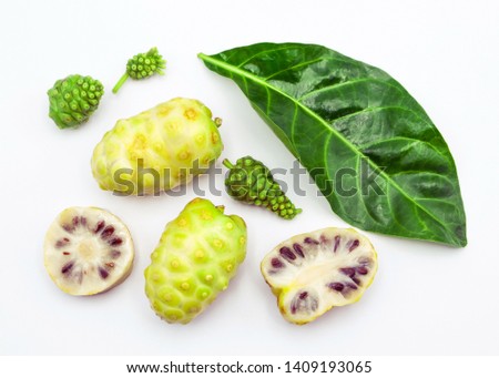 noni fruit with leaf and slice top view on white background.