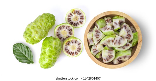 Noni fruit slice in wood bowl on white background. top view