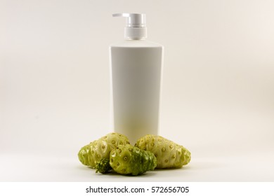 Noni Fruit And White Bottle Isolated.Product From Noni.