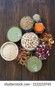 Non-perishable Food, Canned Goods Frame. Pasta, Lentils,rice,nuts,quinoa,beans, Chickpea And Canned Foods On A Wooden Background