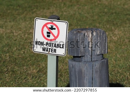 Non-potable water sign next to a wooden post