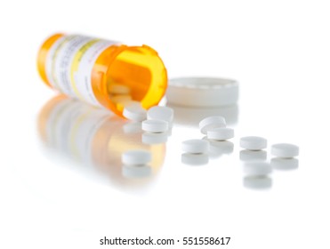 Non-Proprietary Medicine Prescription Bottle And Spilled Pills Isolated On A White Background. This Label Contains Only Fictitious Information.