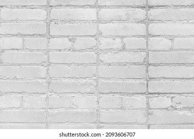 Non-standard irregular amateur brickwork blocks white stone wall texture background.