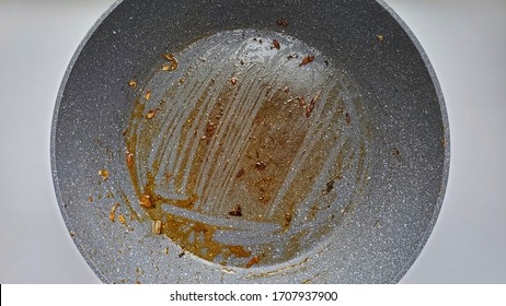 Non-stick Pan Stained With Grease On A White Background