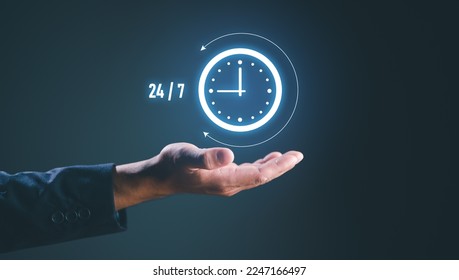 nonstop service concept. businessman hand holding virtual 24-7 with clock on hand for worldwide nonstop and full-time available contact of service concept. customer service.