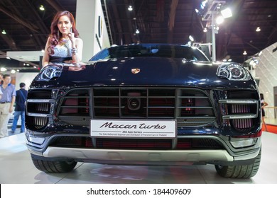 NONTHABURI - March 26: Unidentified modellings posted over Porsche 911 Macan Turbo  display on stage at The 35th Bangkok  International Motor Show on March 26, 2014 in Nonthaburi, Thailand.