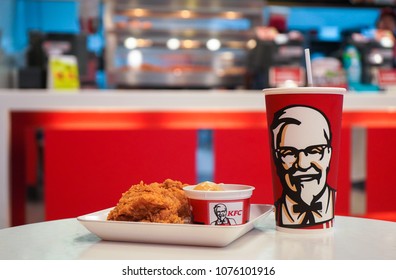 Nonthaburi, Thailand - April 22, 2018 : Cup of KFC's Cola with hot Chicken fried and Mashed potato in the background of KFC (Kentucky Fried Chicken)restaurant.                    