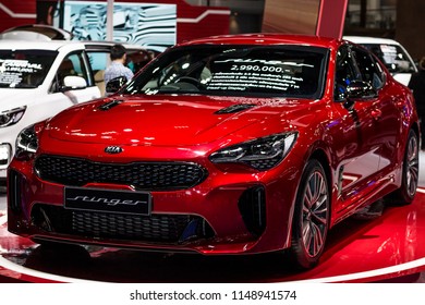 Nonthaburi , Thailand - April 7, 2018: Kia Stinger GT Sports Sedan . Front Side View Car Bonnet With Light Bulb Led For Car Headlights . Red Color Luxury Automobile In Show Room .