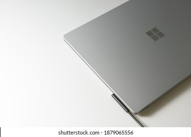 Nonthaburi, Thailand - December 20 2020: Close-up top view of Surface Laptop 3 Platinum Color by Microsoft with charger adapter on white background