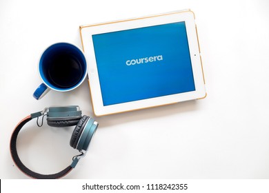 Nonthaburi, Thailand -June 17, 2018: Flat Lay Of Tablet, Headphone And Blue Mug Isolated On White. The Tablet Screen Showing Coursera Icon. Coursera Is A Popular Online Learning Course Platform.