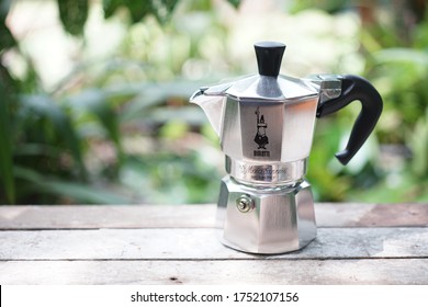 Nonthaburi, Thailand - June 6 2020 : Silver Moka Pot - 1 Cup, Bialetti Moka Express, Brewing the fresh coffee in the green garden background