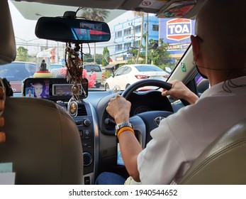 Nonthaburi, Thailand, March 2021, Taxi driver at rush hour on the road. - Shutterstock ID 1940544652