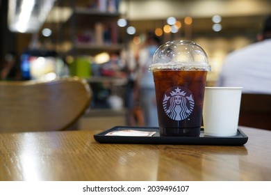 Nonthaburi, Thailand - Sep 10, 2021 : Cup of Starbucks Reserve Sulawesi Toraja Sapan Village in the background of Starbucks coffee shop. Starbucks is the largest coffeehouse company in the world.     