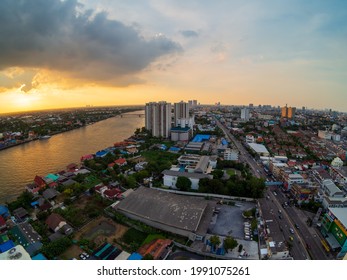 Nonthaburi Thailand,20Apr2021,Cityscape Taken With Fisheye Lens, City View High Angle From Rooftop Tall Building Capital Showing Distant And Wide. In Evening, Sunset, Golden Orange Light Dark Cloud.