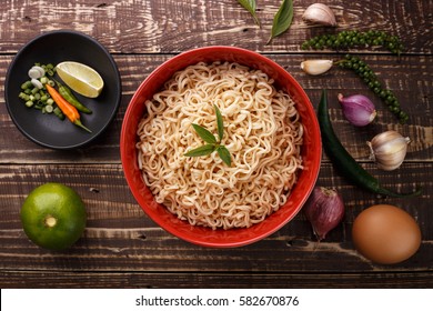 Noodle In Bowl And Ingredients On Wood Background Top View