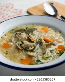 Noodle soup with clams and carrots and other seasonal vegetables. - Shutterstock ID 2365385269