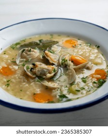 Noodle soup with clams and carrots and other seasonal vegetables. - Shutterstock ID 2365385307