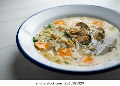 Noodle soup with clams and carrots and other seasonal vegetables. - Shutterstock ID 2365385329