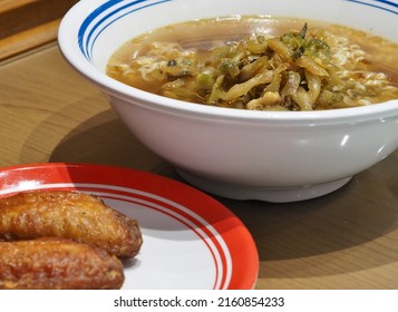 Noodle soup with fried chicken wings , pork and pickled mustard tuber