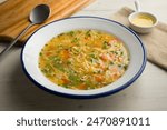 Noodle soup with vegetables. Traditional recipe of Spanish gastronomy.