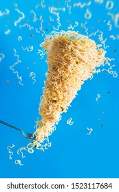 Noodle Tornado With A Fork, Instant Ramen In Action. Inspiration Concept With Creative Food Photography And Motion.