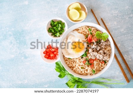 noodles bowl with boiled egg minced pork vegetable spring onion lemon lime lettuce celery and chili on table food, noodle soup instant noodles cooking tasty eating with plate - top view