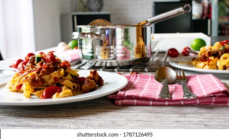 Noodles With Meat And Italian Vegetables On A White Plate Served On A Table - Ready To Eat - Family Dinner At Home