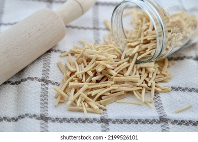 Noodles poured out of glass jar with rolling pin. Turkish cuisine noodles. Turkish noodles. Erişte.  - Shutterstock ID 2199526101