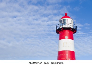 "Noorderhoofd"  lighthouse in Westkapelle, Netherlands. It has 3 colors of light, white (6000 candela), red and green (1800 cd). Together with another lighthouse it sends its  beacon to the "Oostgat" - Shutterstock ID 130834346