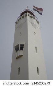 Noordwijk Vuurtoren lighthouse with Dutch flag on top, low angle view, concept: guidance orientation, safety (vertical), Noordwijk, South Holland, Netherlands
