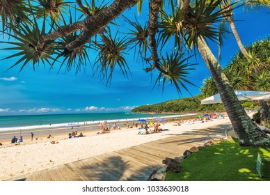 NOOSA, AUSTRALIA, FEB 17 2018: People enjoying summer at Noosa main beach - a famous tourist destination in Queensland, Australia.